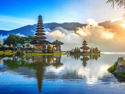 Traditional Balinese temple surrounded by water by the mountains.