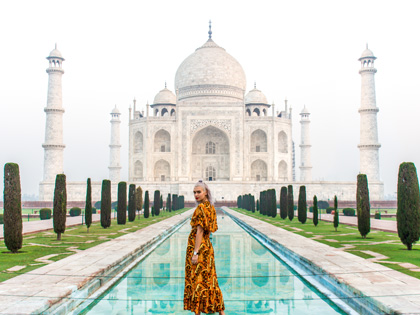 Woman posing in front of the Taj Mahal