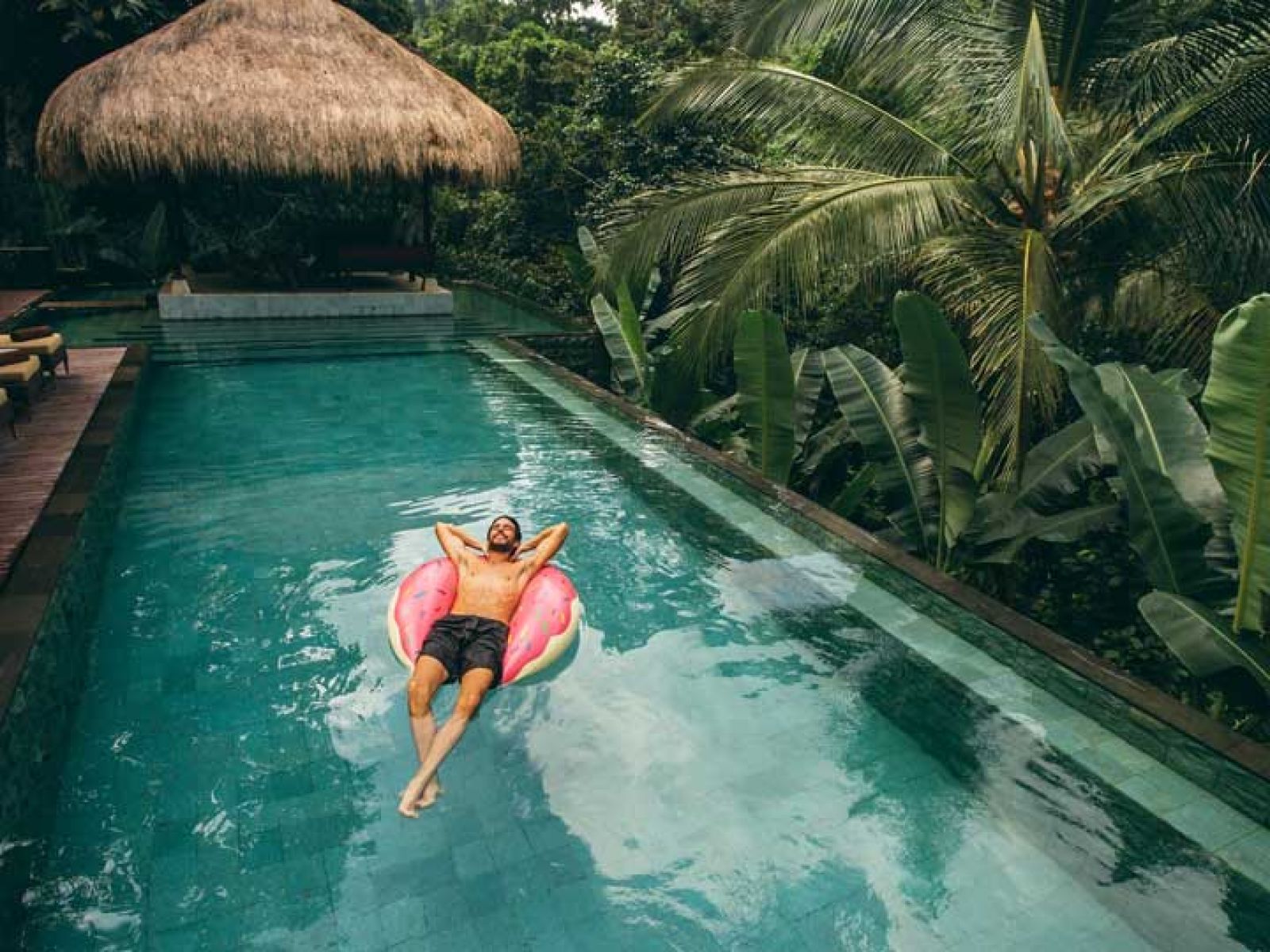 A man lounging in a pool in Bali 