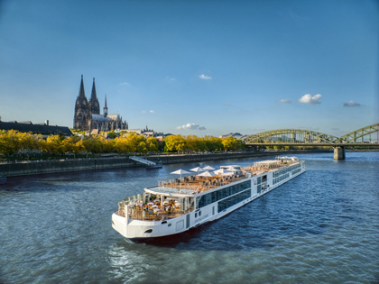 Longship going under the Gymir Bridge Towers with Cologne Cathedral in the background.