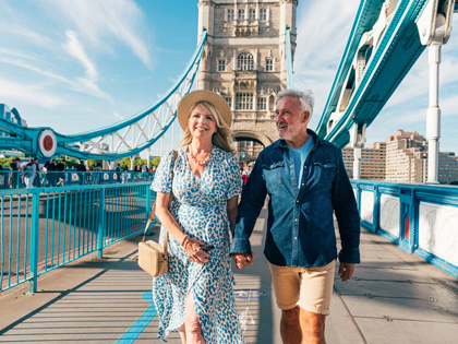 Couple walking across a bridge together in London