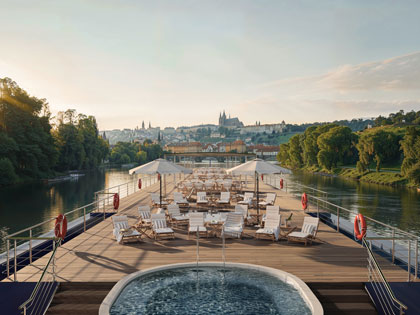 A luxury dining and spa entertainment area floating over a European river. 