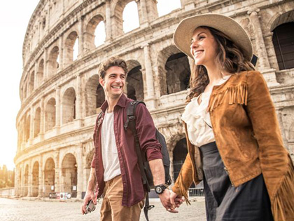 Couple holding hands at the Colosseum.