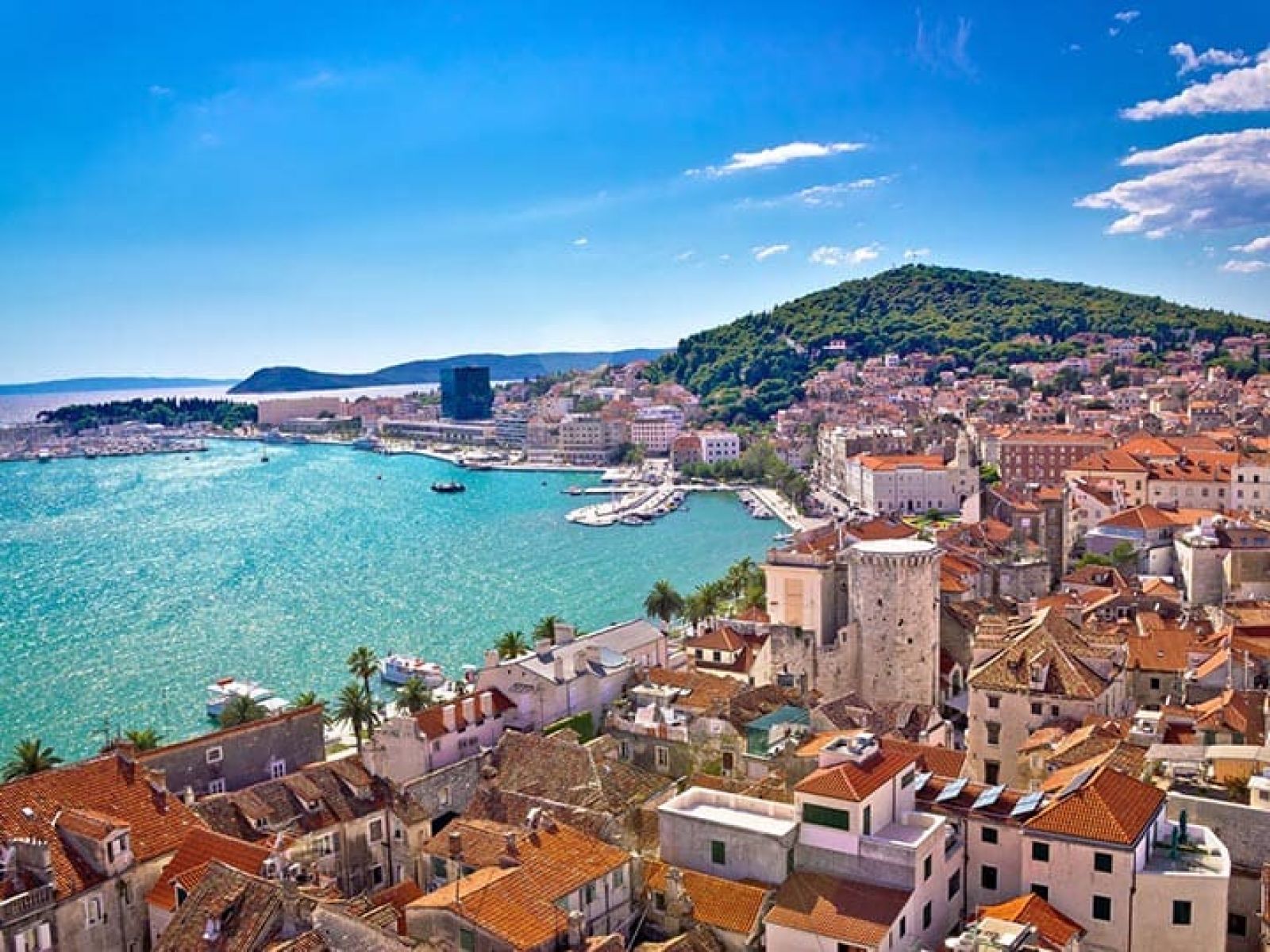 Panoramic view of Dubrovnik, Croatia, featuring the old town, sea and hills.