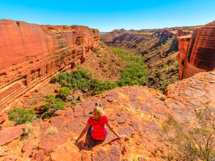 Tourist woman sitting at on a canyon