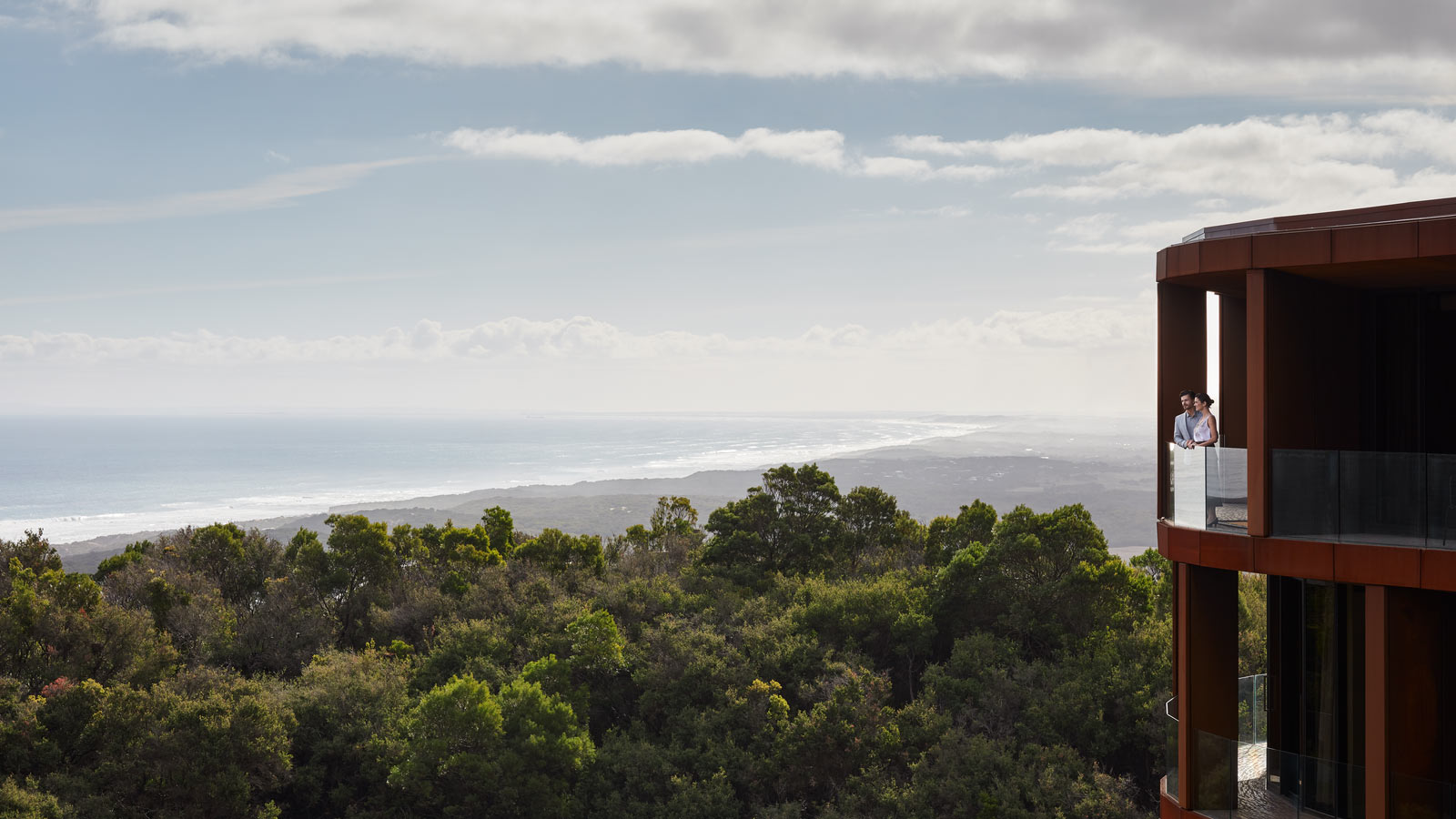 Couple standing on the balcony of a Superior room at RACV Cape Schanck Resort.