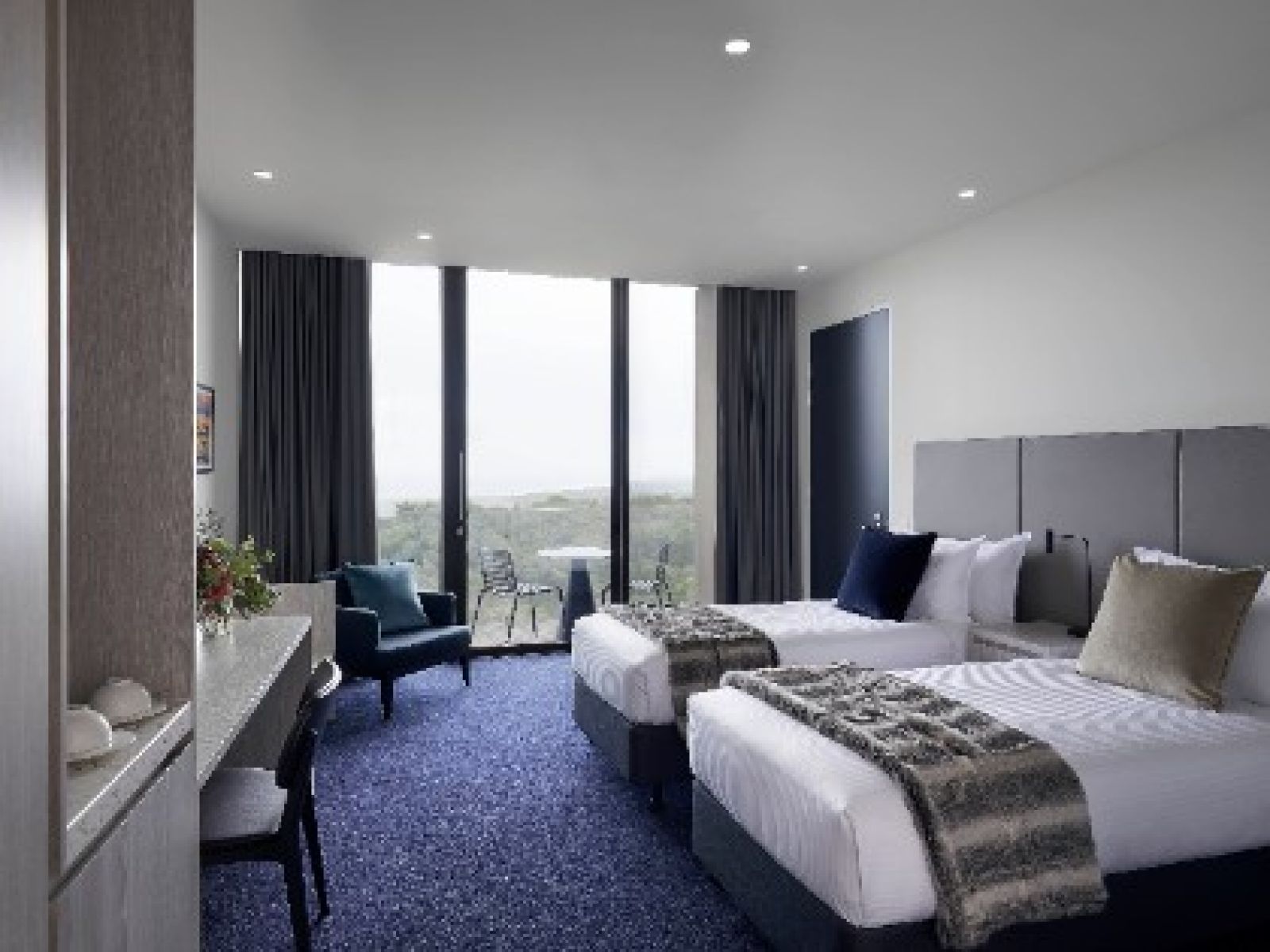 2 well-appointed single beds feature in one of the bedrooms of RACV Cape Schanck Resort's Superior Family Room.