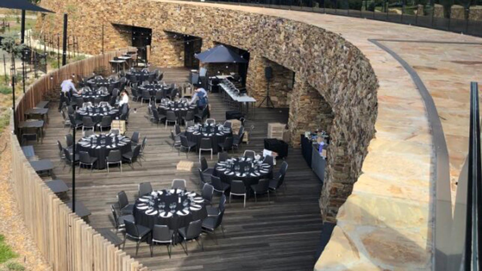 Outdoor terrace at RACV Cape Schanck Resort, featuring tables set up banquet style.