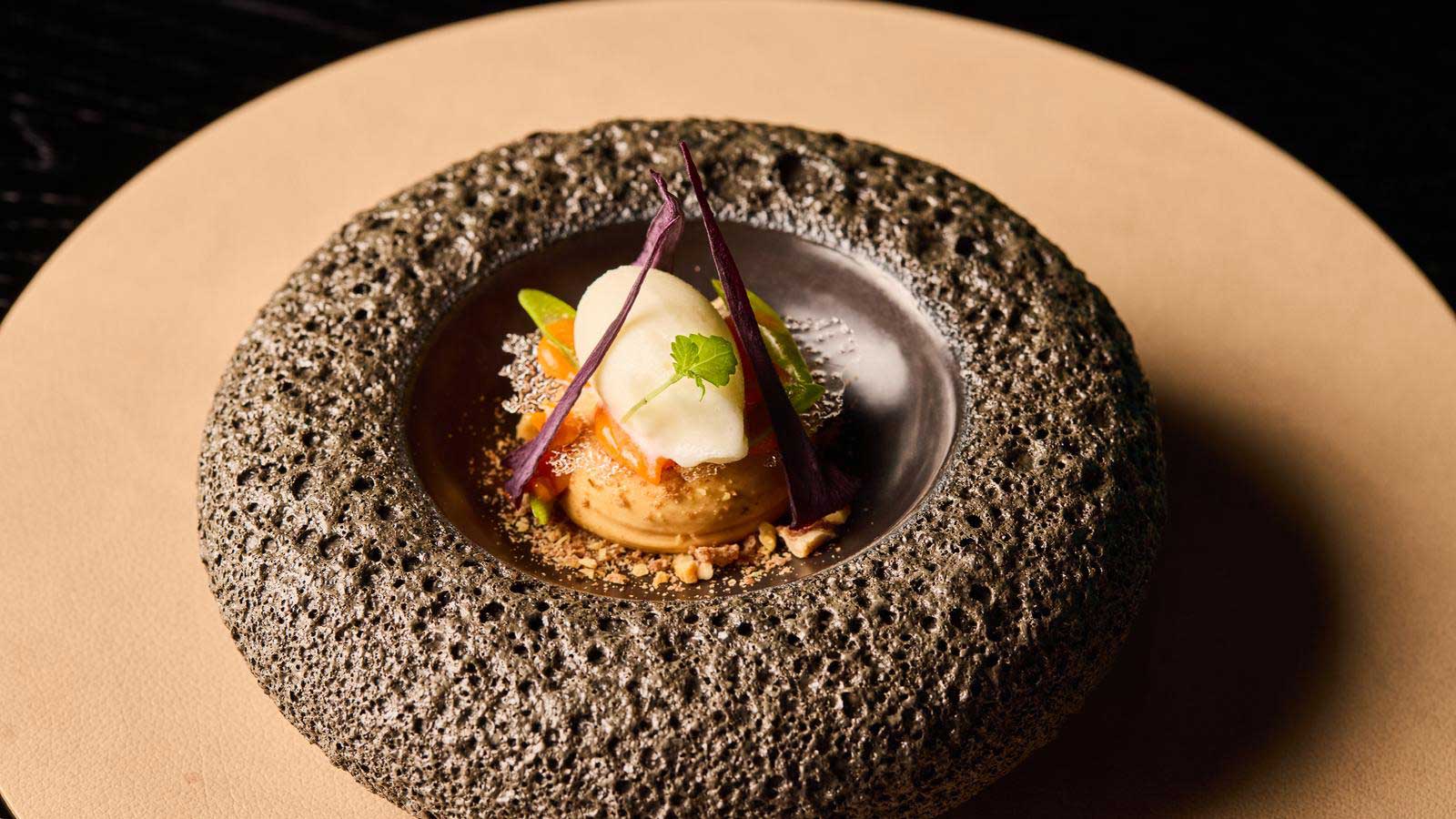 A dessert presented beautifully in a stone style bowl. 