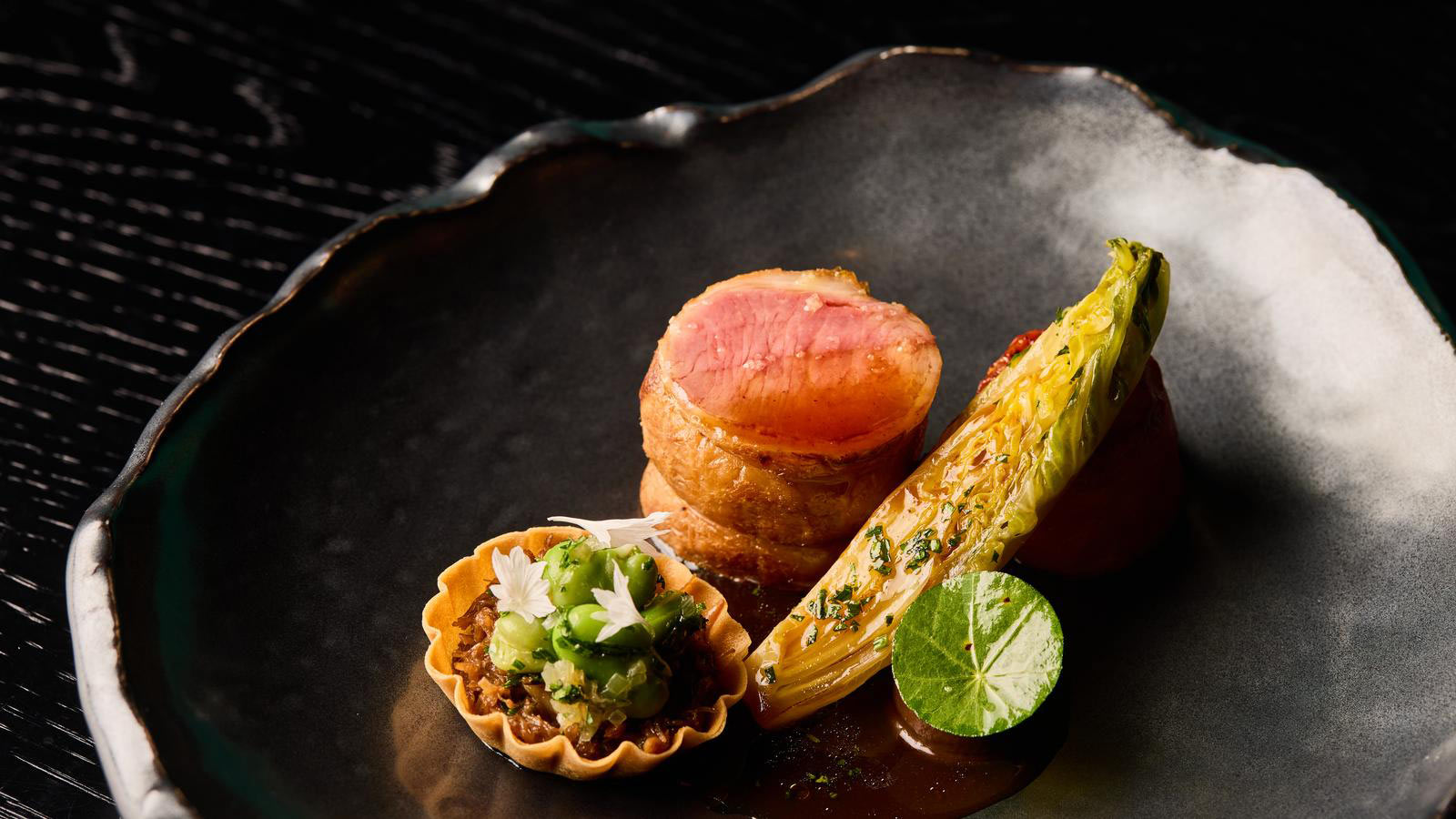 Several dishes presented beautifully in a bowl. 