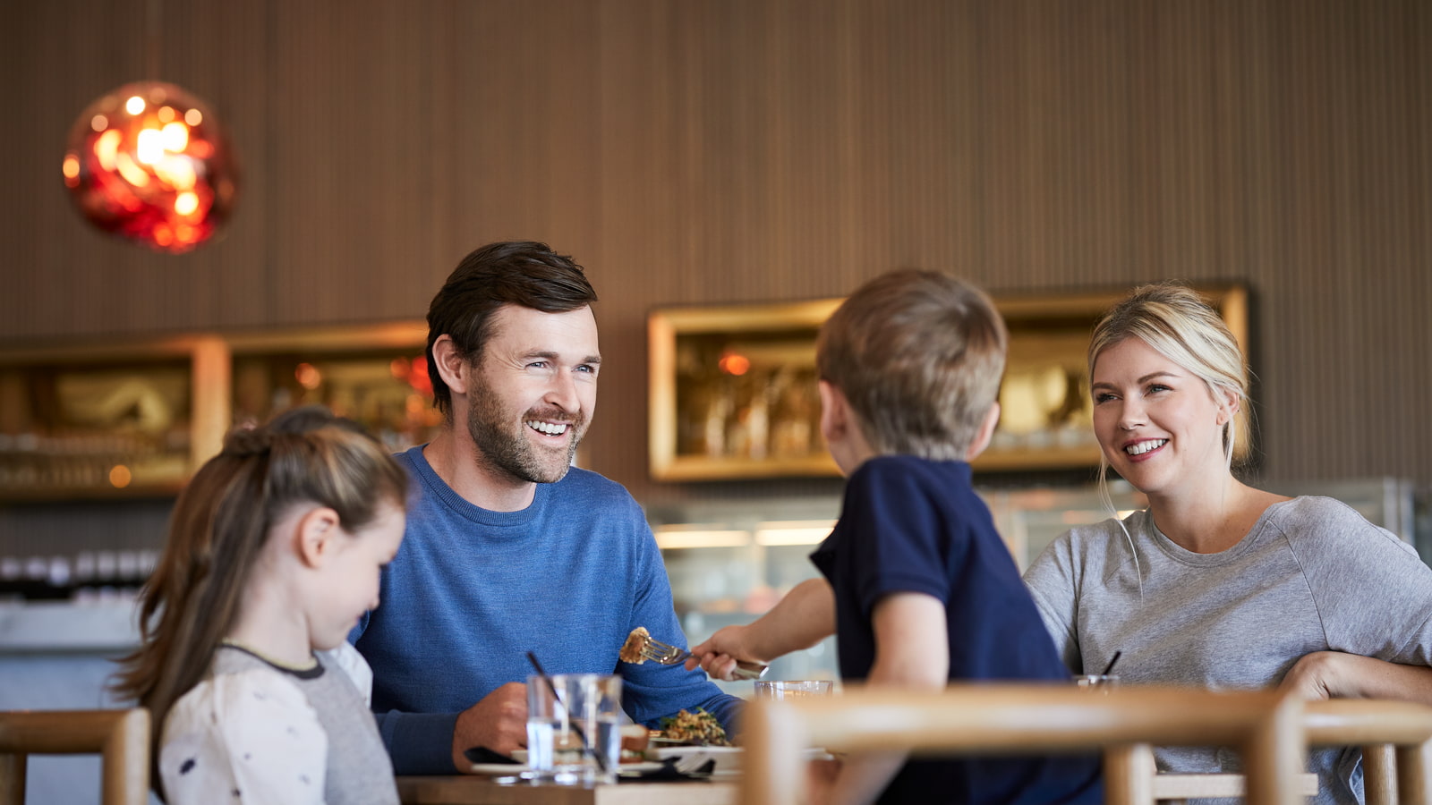 Family dining at a table in RACV's Mantellina restaurant.