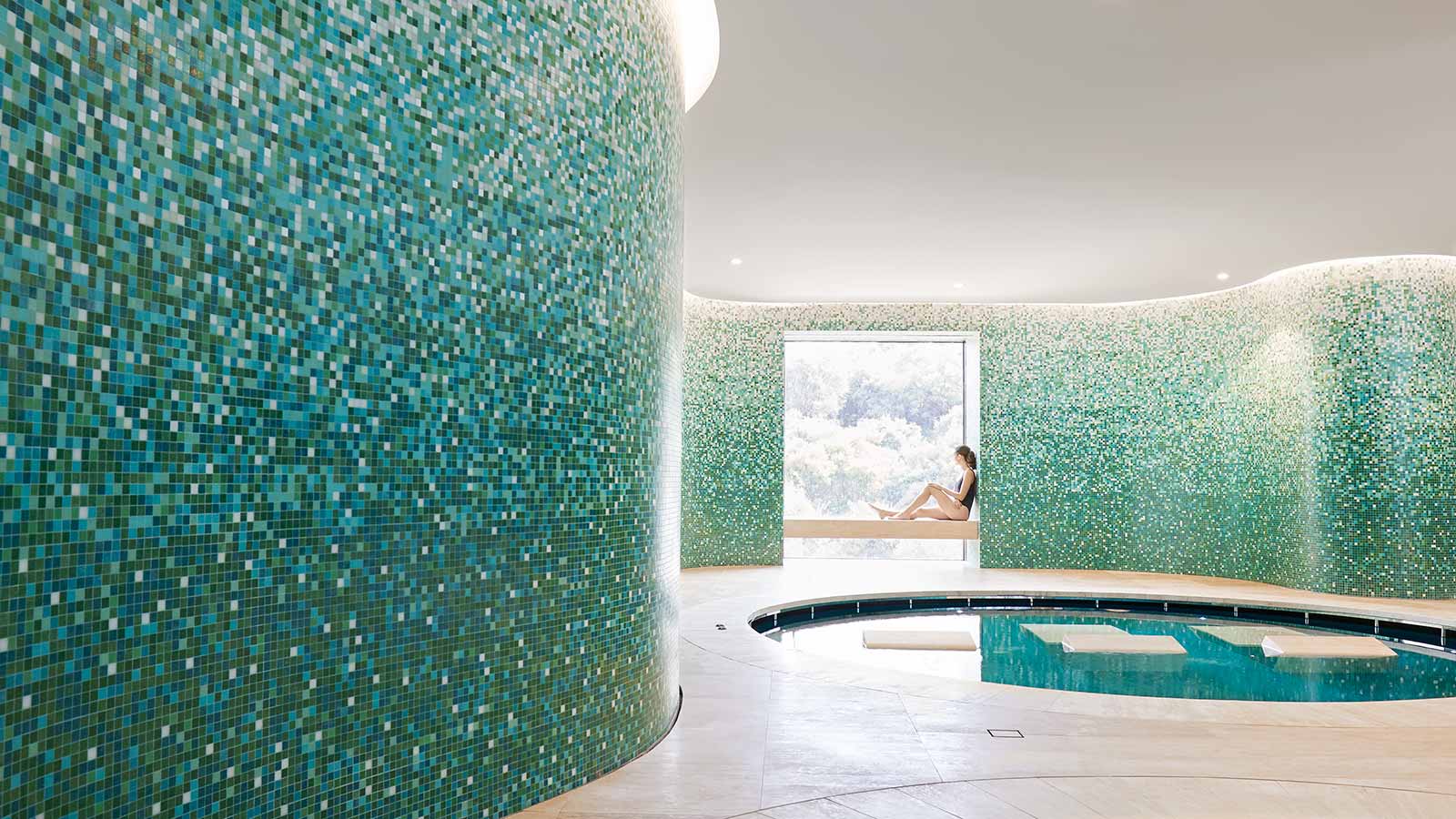 Woman sitting up against window in hammam bathing room at RACV Cape Schanck Resort's One Spa.