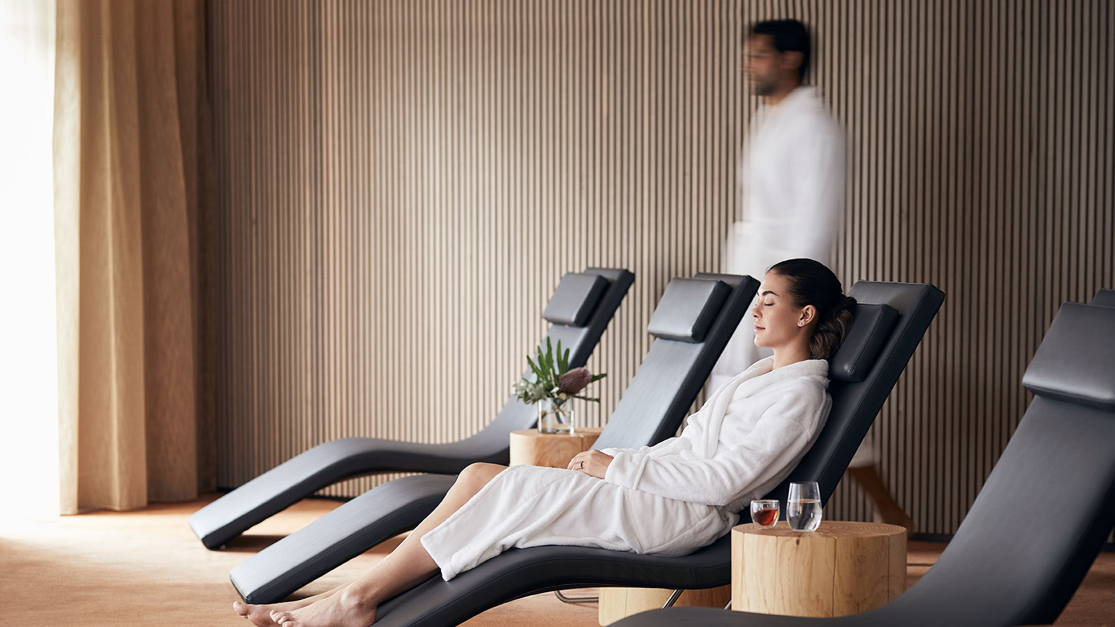Person in a robe lying down in the relaxation lounge at RACV Cape Schanck Resort's One Spa.