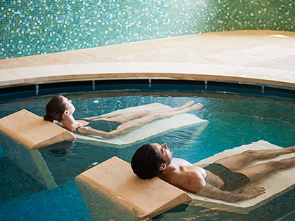 Two people lying down in the water beds provided in the hammam bathing facility at RACV Cape Schanck Resort's One Spa.