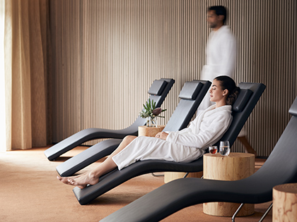 Person in a robe lying down in the relaxation lounge at RACV Cape Schanck Resort's One Spa.