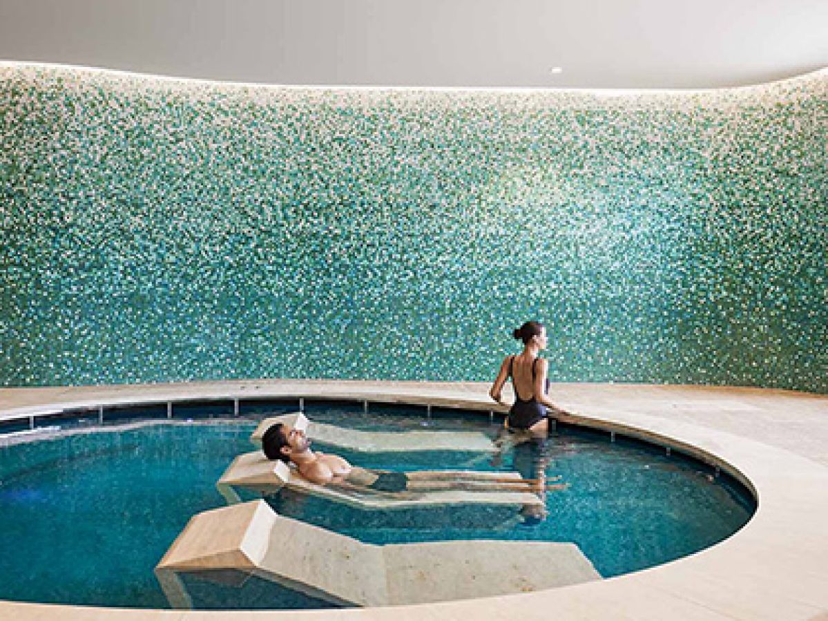 Two people in a pool with day beds at Cape Schanck One Spa.