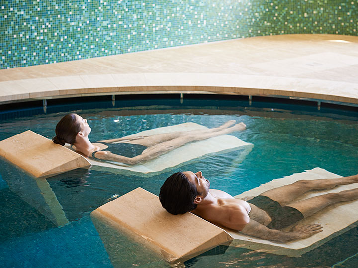 Two people lying down in the water beds provided in the hammam bathing facility at RACV Cape Schanck Resort's One Spa.