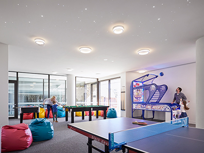 Games room at RACV Cape Schanck Resort, featuring a table tennis table, pool tables and arcade basketball game.