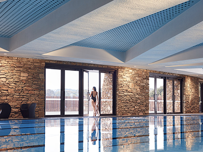 Person in bathing suit walking out of indoor pool room at RACV Cape Schanck Resort.
