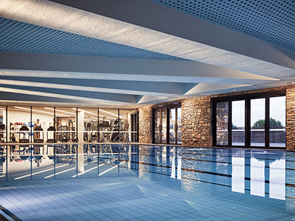 An indoor pool at RACV Cape Schanck Resort, with a gym behind it.
