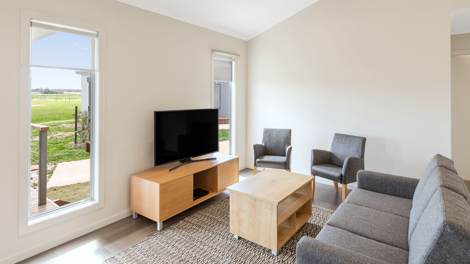 Lounge room in a garden view cabin at RACV Cobram Resort.