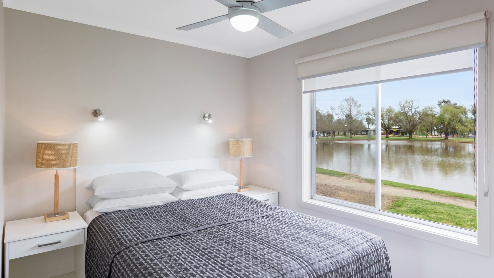 Double bed in bedroom of lakeview cabin at RACV Cobram Resort.
