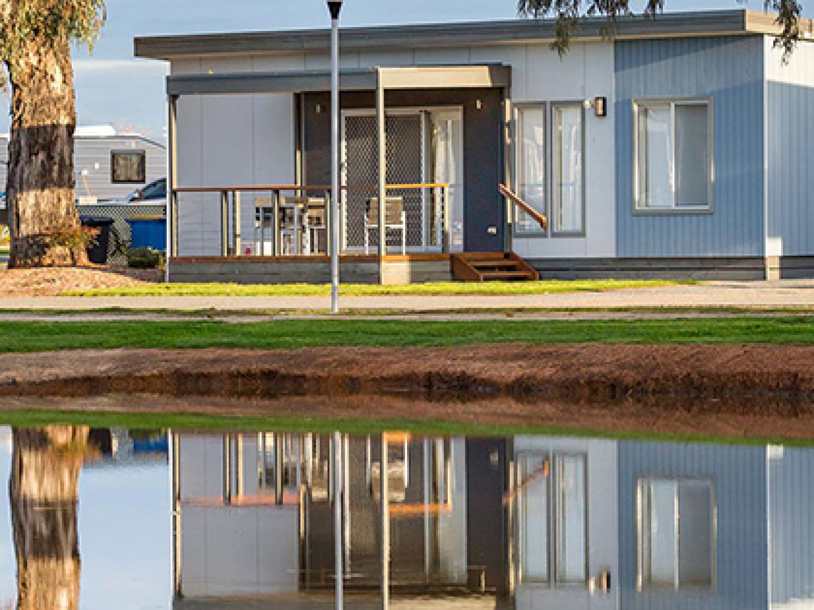 Accommodation cabins next to a lake at RACV Cobram Resort.