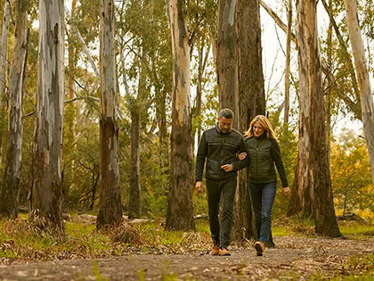 Two people walking in bushland in Cobram.