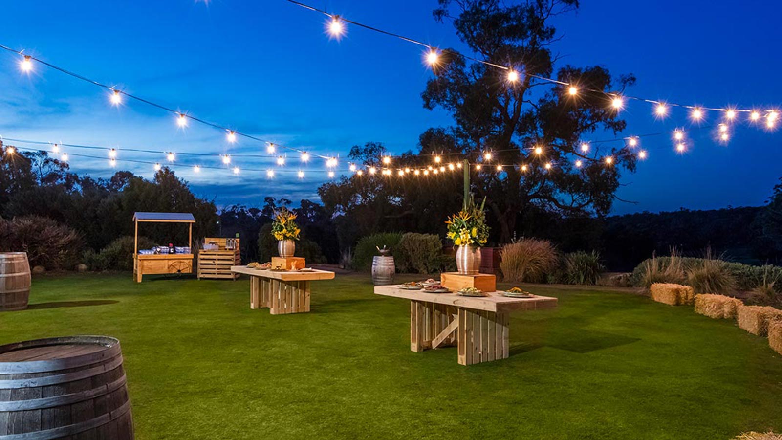 Outdoor garden at RACV Goldfields Resort at evening, with fairy lights hung up.