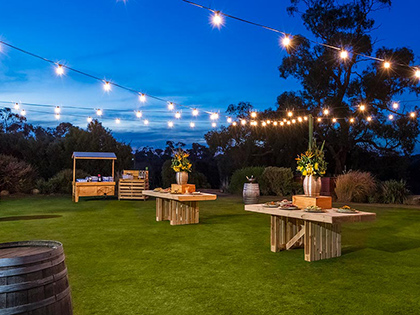 Outdoor garden at RACV Goldfields Resort at evening, with fairy lights hung up.