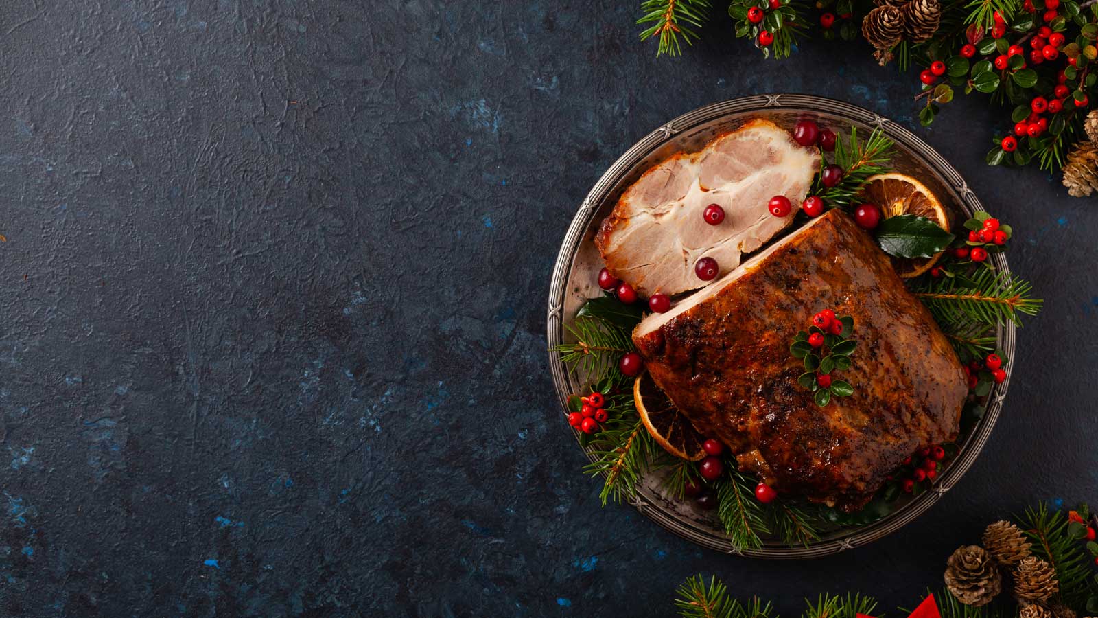 Roast ham Christmas style on a dark navy background