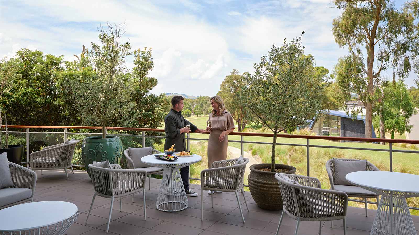 Two people talking at RACV Goldfields Resort's Springs Bar and Terrace.