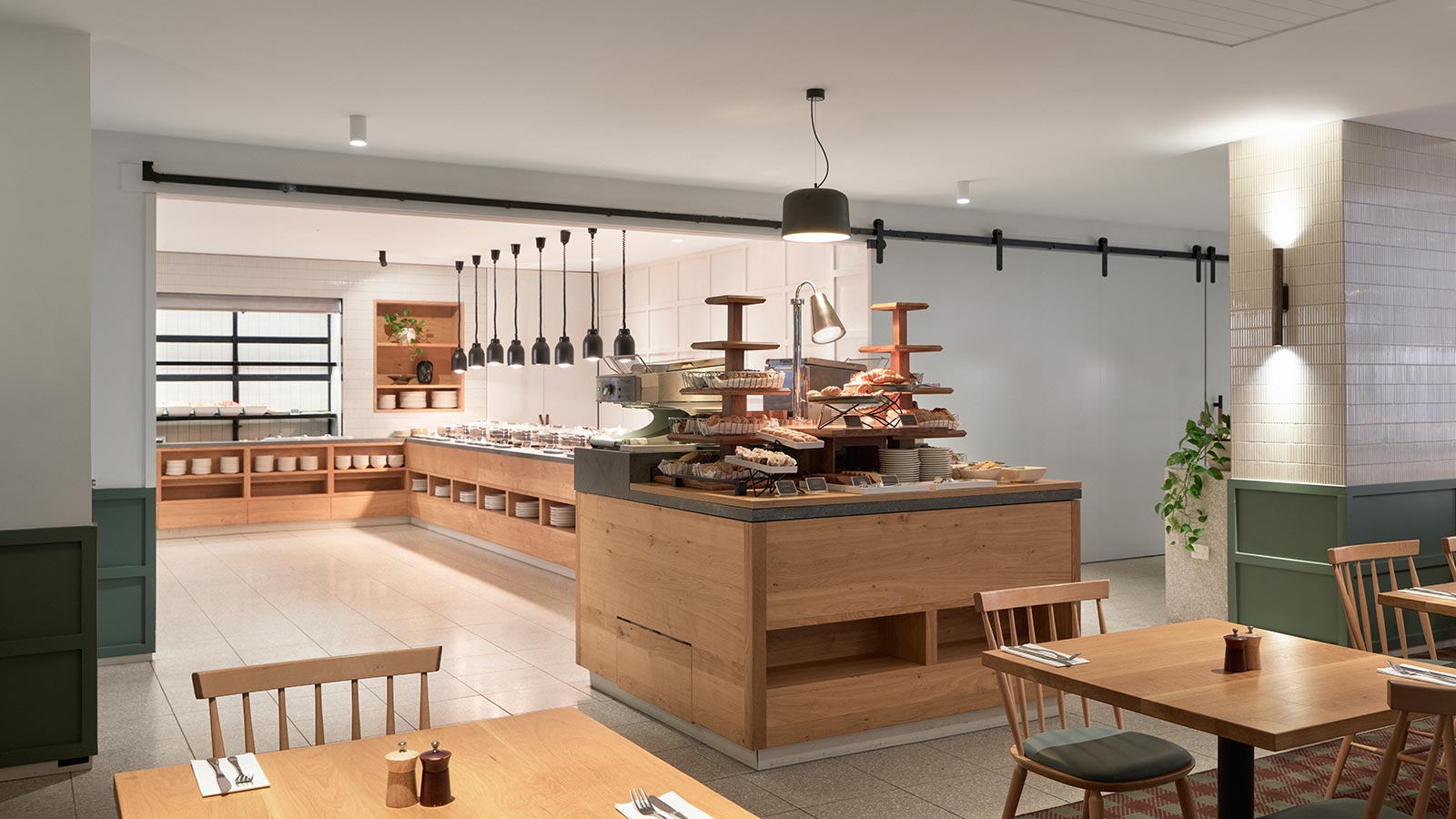 Buffet at RACV Goldfields Resort's Three Founders restaurant, featuring bread and pastries next to steel containers of food.