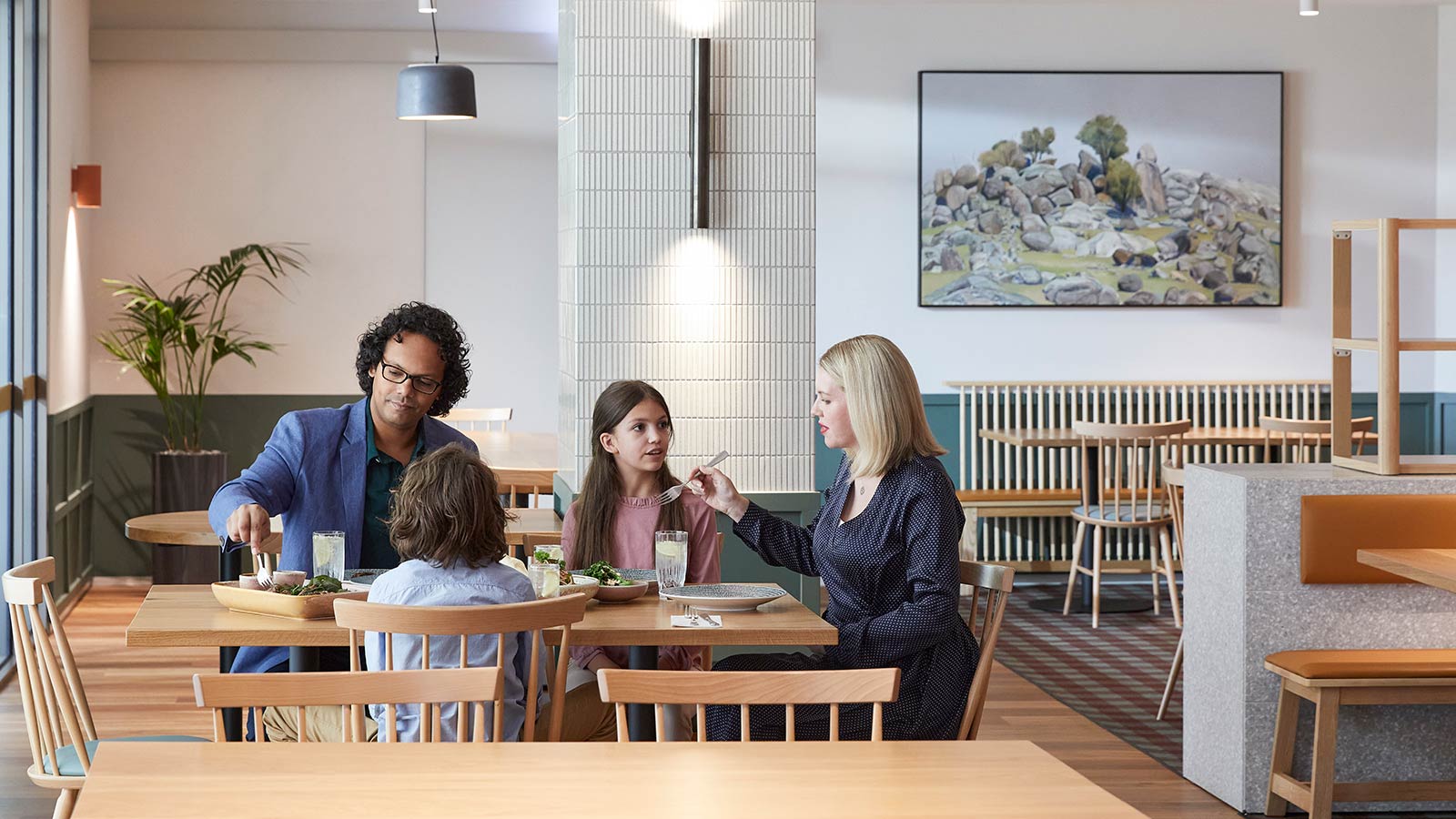 Family sharing a meal inside Three Founders restaurant at RACV Goldfields resort.