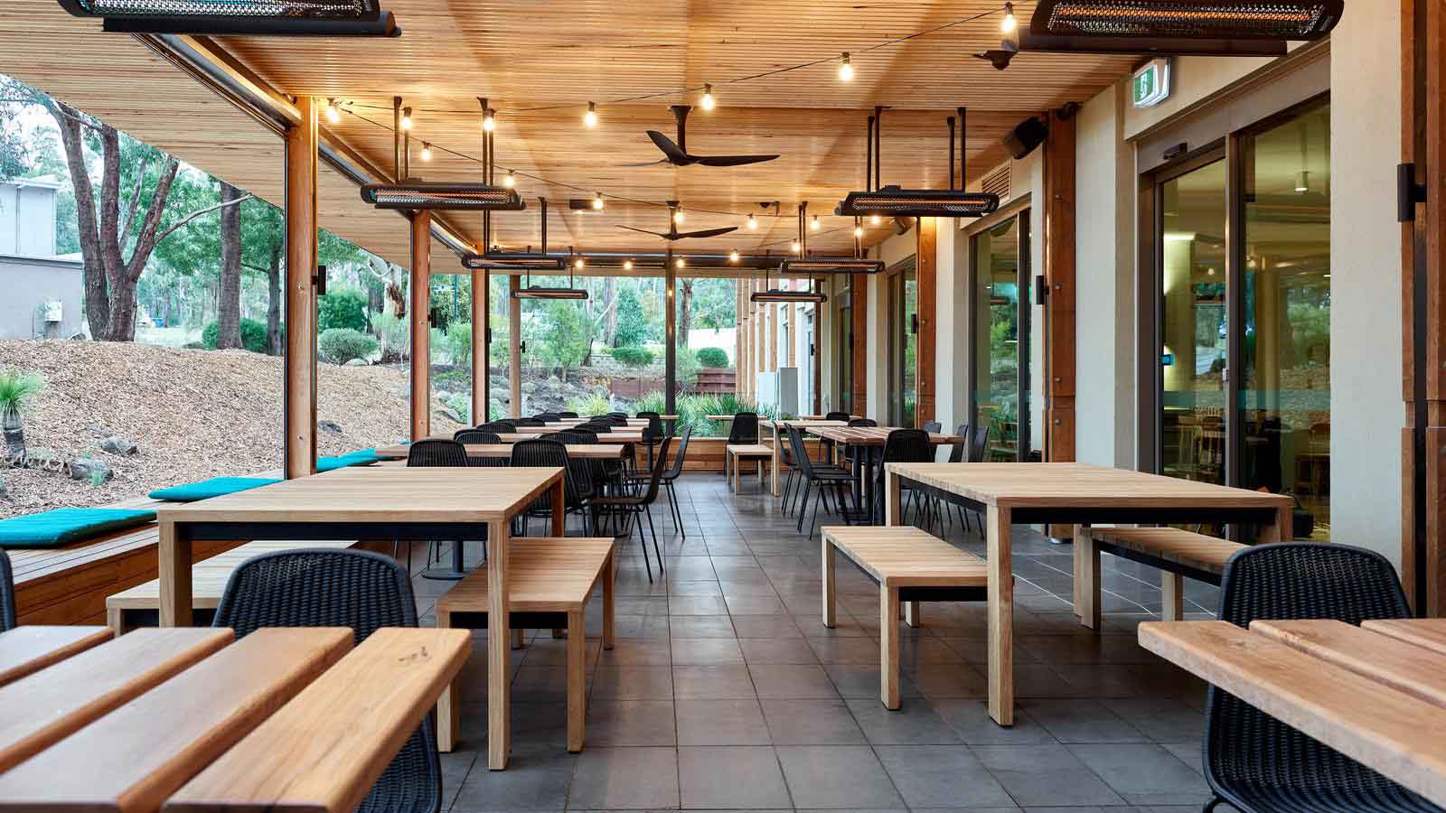 A shot of the tables and benches in the outdoor area of Three Founders, Goldfields resort.