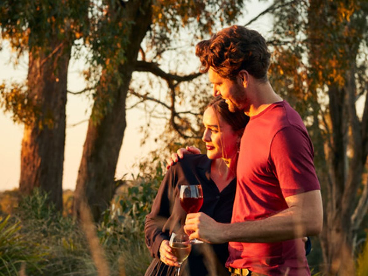 Couple enjoying some wine in the bushland near Goldfields. 
