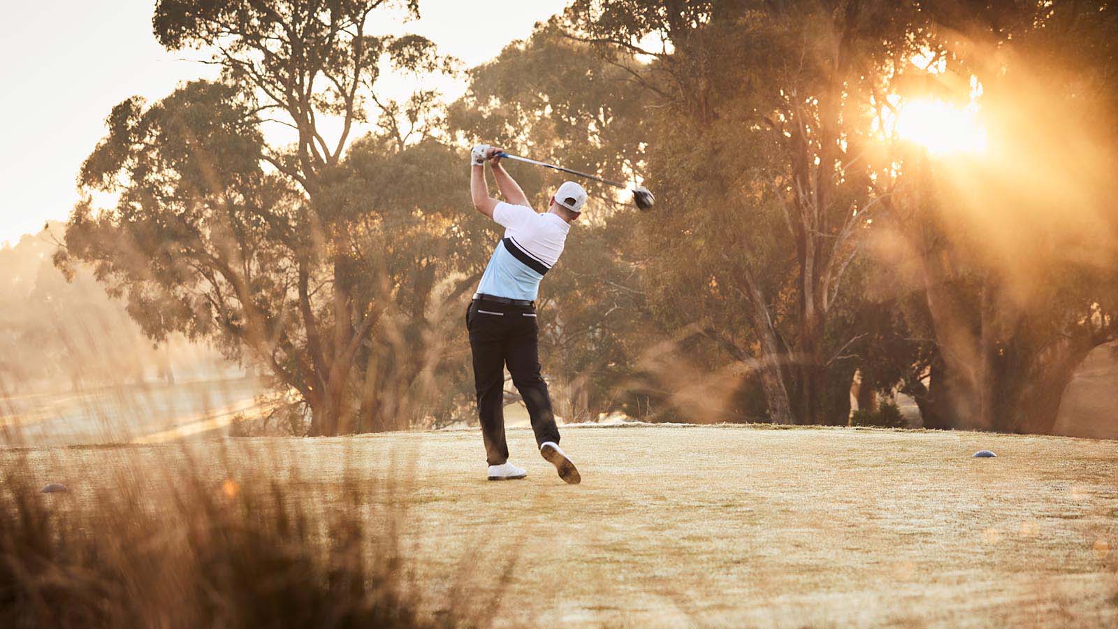 Man playing golf on fields at RACV Goldfields Resort near Ballarat.