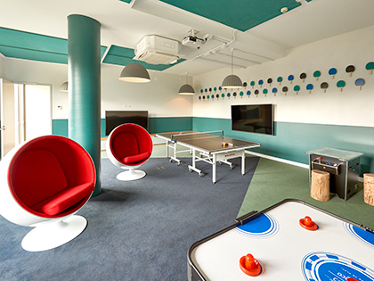 Games room at RACV Goldfields Resort, featuring a table tennis table, ice hockey table, pod chairs and television.