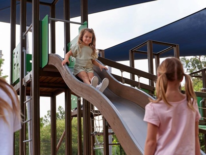 Two girls enjoying the playground at Goldfields resort.