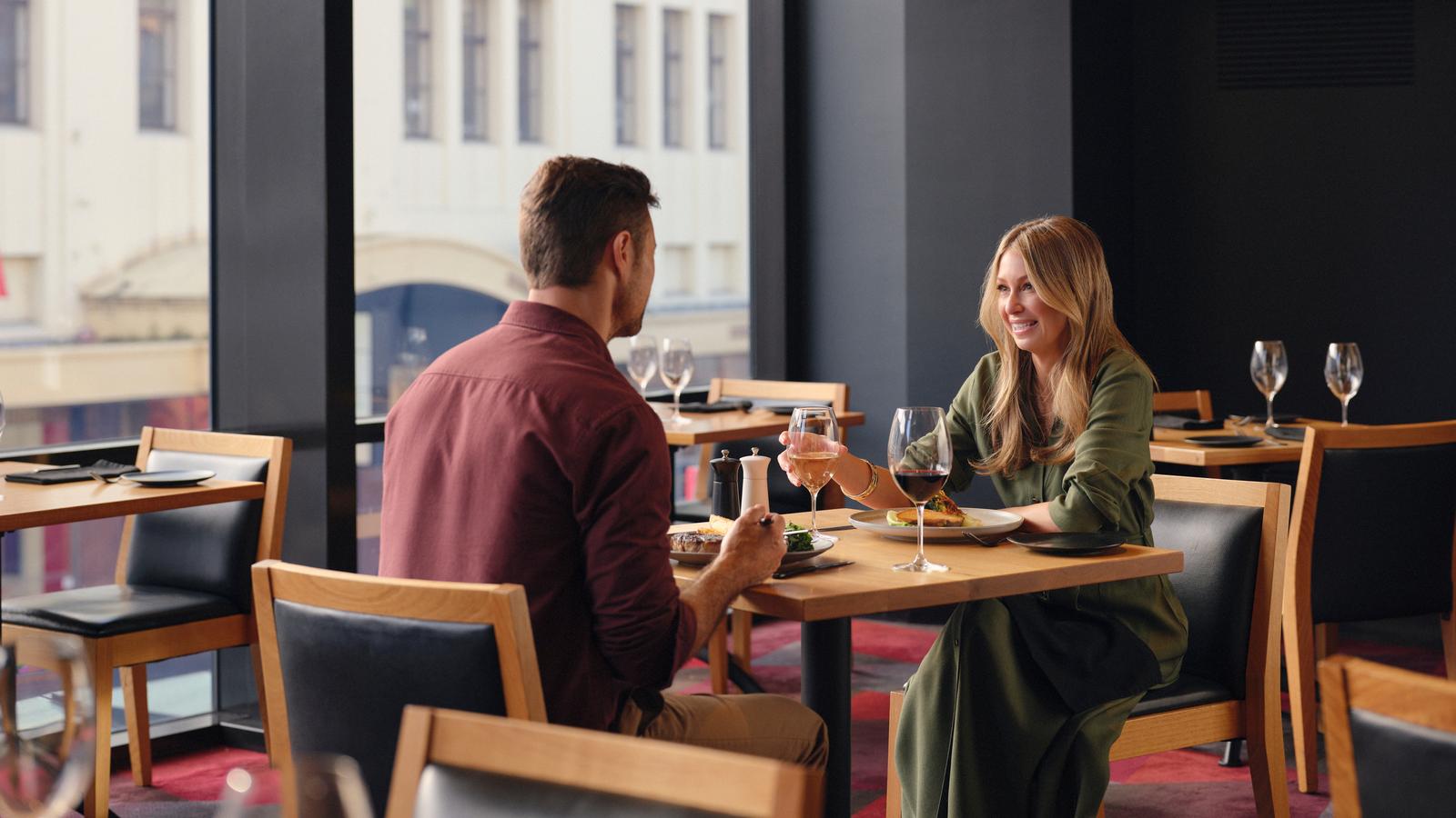 Couple enjoying a meal together at Charcoal restaurant