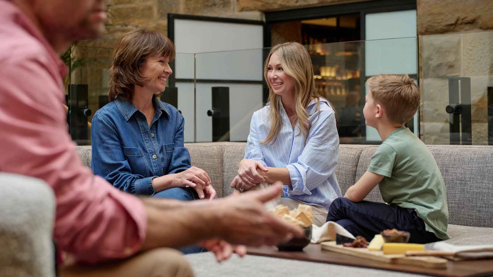 A family enjoying a cheeseboard in the lounge of the Hobart Hotel restaurant.