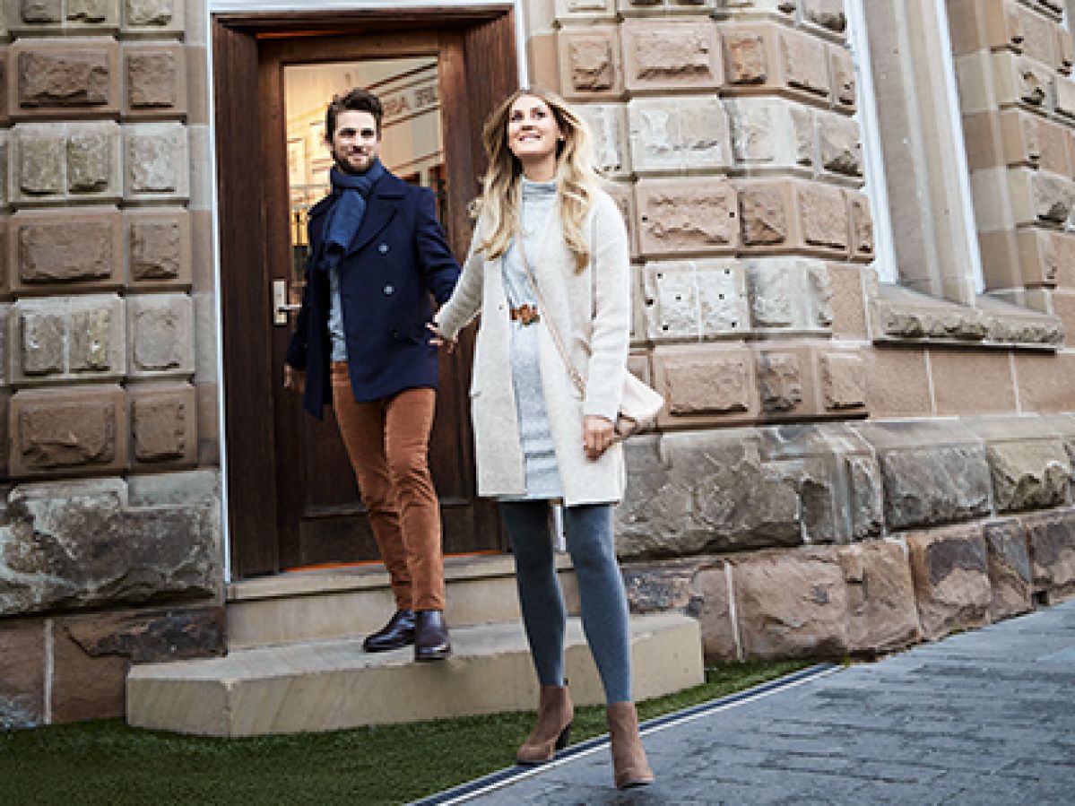 Couple holding hands and smiling just outside the front door of RACV Hobart Hotel's Cascade on Collins bar.
