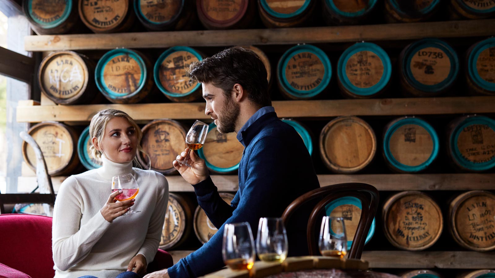 Couple doing a whisky tasting at a bar in Hobart.