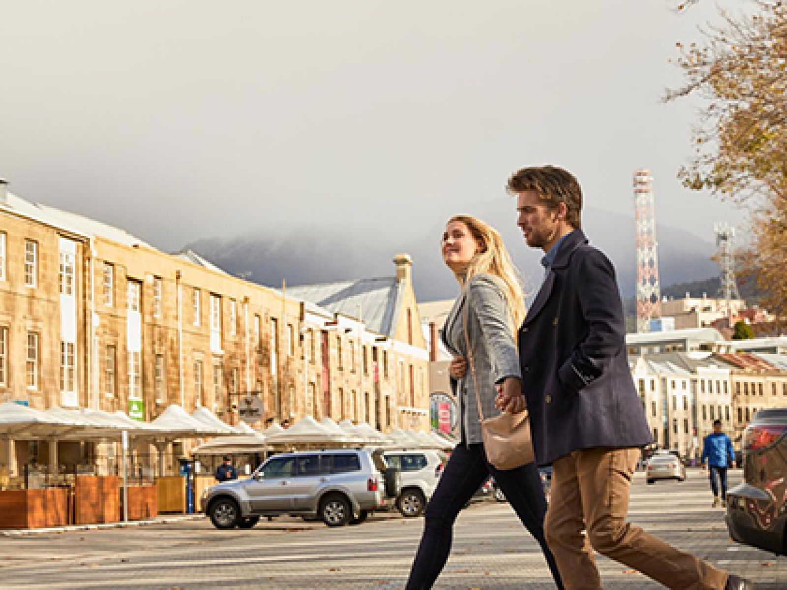 Couple walking through Salamanca streets in Hobart.
