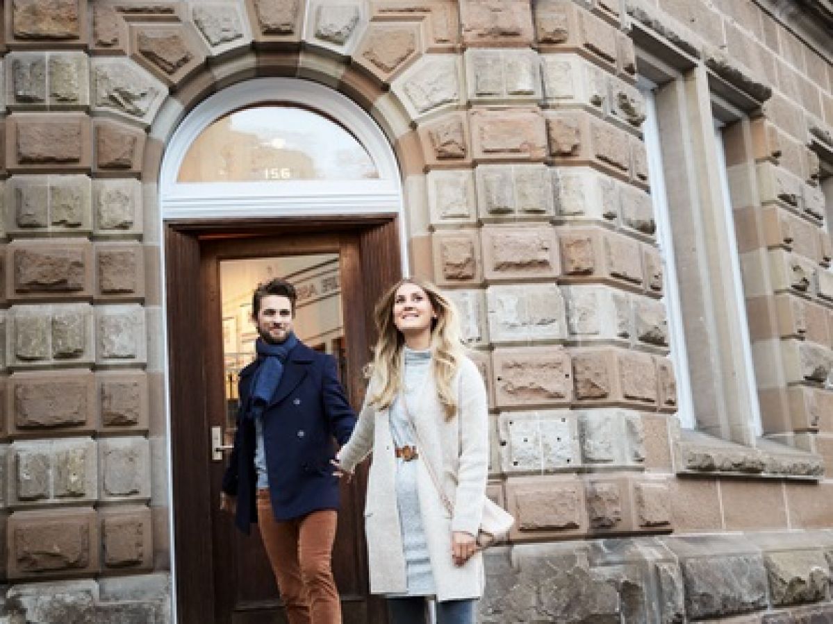 Man and woman holding hands as they leave Cascade Restaurant in Hobart.