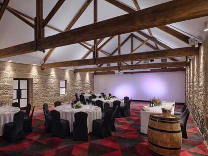 The Stables set up for a wedding dinner service. 