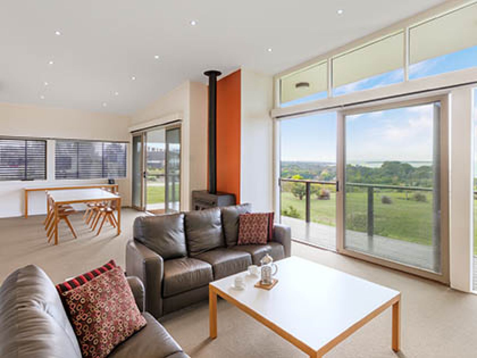 Lounge and dining area, with outdoor deck in Premium 2-bedroom Ocean Villa at RACV Inverloch resort.