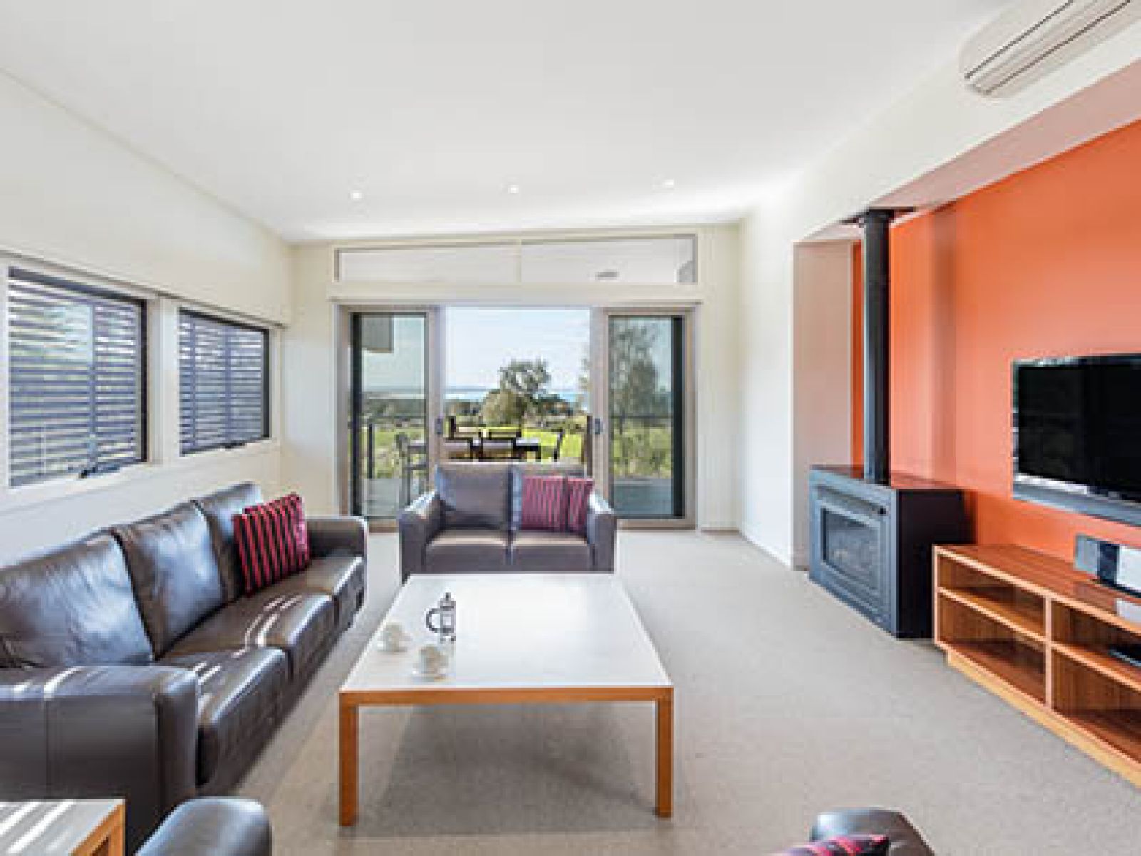 Lounge area and outdoor deck in Premium 3-bedroom OCean Villa at RACV Inverloch resort.