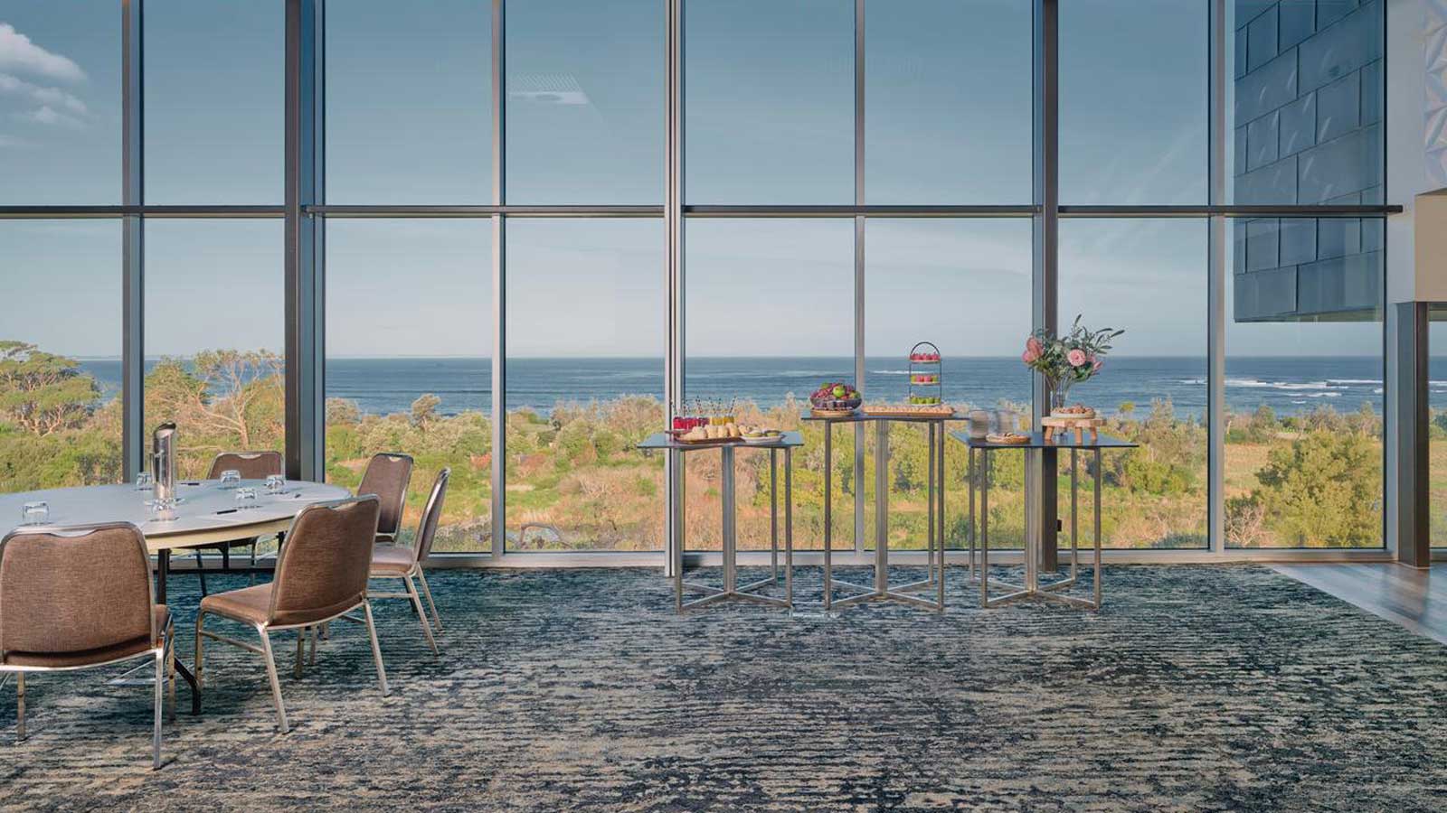 Panorama room at RACV Inverloch Resort,, with a food station and sweeping ocean views.