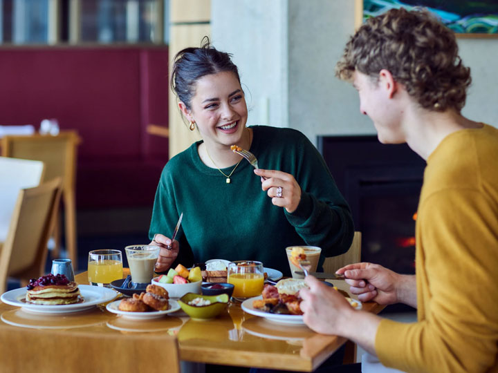 Couple eating breakfast together at Inverloch